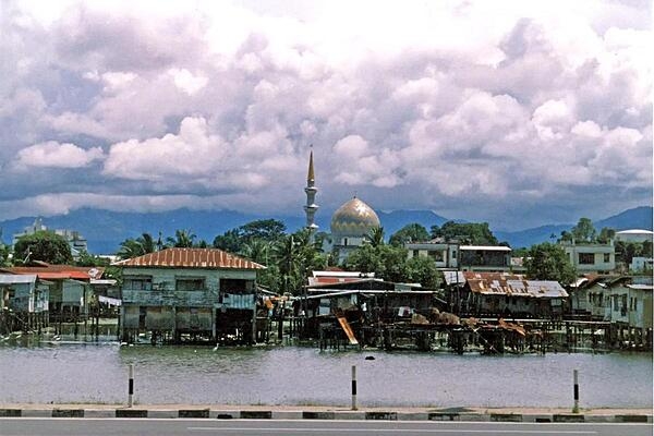 Another view of the water village of Kampong Ayer; the Sultan Omar Ali Saifuddin Mosque looms in the background.