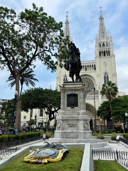 In the heart of downtown Guayaquil, Ecuador, is Parque Seminario, better known as "Iguana Park" for the dozens of iguanas that call it home. The picture shows the park's statue of Simon Bolivar, and in the background is Metropolitan Cathedral. The cathedral is the successor to the church that was located here when the city was originally founded in the 16th century.
