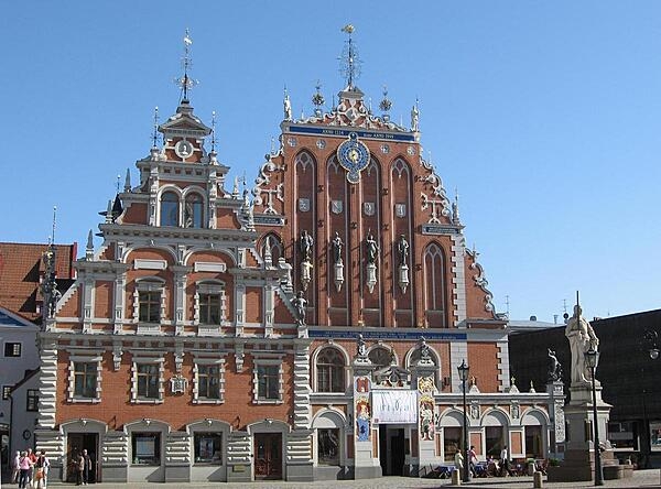 The House of the Blackheads located in old town Riga, Latvia was first built in the 14th century for The Brotherhood of the Blackheads, a guild for unmarried merchants, ship-owners, and foreigners in town. The building was bombed by the Germans in 1941 and demolished by the Communists in 1948. Only the cellar survived all the destruction. Reconstruction of the building took place between 1996 and 1999 and today it is an iconic orange Gothic building with an astronomical clock and sculptures of mythological characters; it serves as a museum and concert hall.