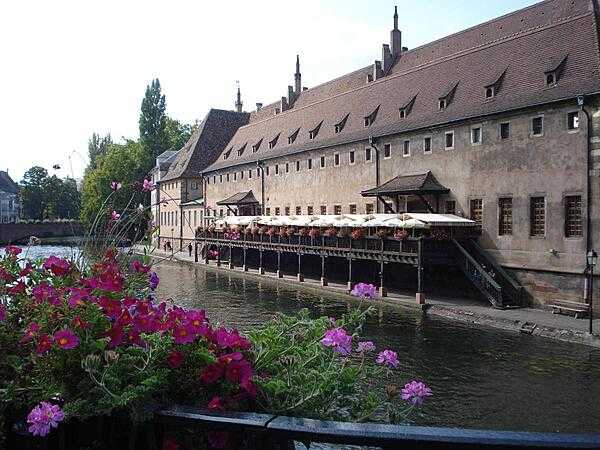 The old customs building (L'Ancienne Douane) on the Grande Ile in Strasbourg, France. Constructed in 1358, the structure housed the port and tax authorities, and it was used to store goods and merchandise going up and down the Rhine River. Today the building houses a restaurant.