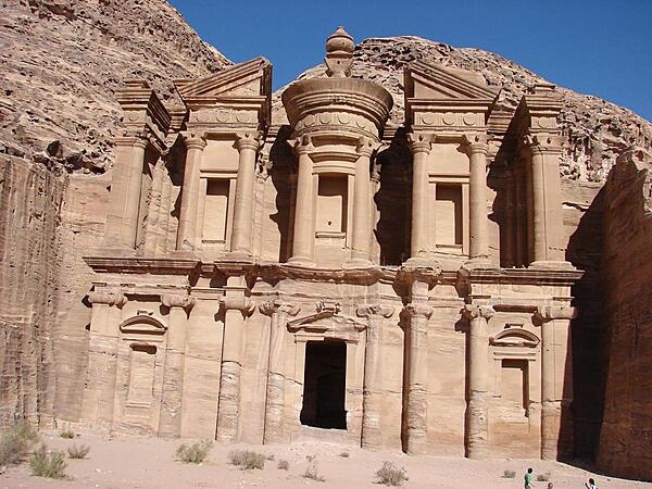 About 200 km (125 mi) south of the capital city of Amman, Jordan, lie the ruins of Petra, the "Rose City" and one of the New Seven Wonders of the World. This monastery, dedicated to the god Obodas, dates from the first century BC and is Petra’s largest monument.