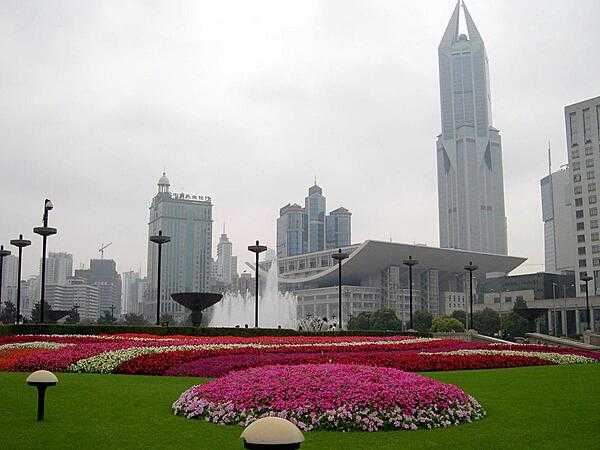 The Grand Theater in Shanghai, the largest city in China with over 20 million citizens. Shanghai is the largest center of commerce and investment in China, as well as a popular tourist destination. The distinctive tall building in the background, Tomorrow Square, houses a hotel and apartment units.