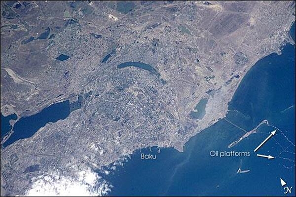 Baku is Azerbaijan&apos;s major city, and the oil capital of the Caspian region. This photo shows details of the city, including the extensive port facilities, and part of the large web of offshore oil platforms in the Caspian Sea. The oil platforms off Baku were built in the 1950s and 1960s, and were the first offshore oil-drilling efforts in the world. Today, multinational oil exploration, sea-level rise (the Caspian Sea has risen more than 2 m in the past 20 years), offshore platform maintenance, and environmental degradation are all hot topics in Baku. Image courtesy of NASA.