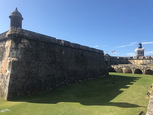 Wall and garita shadows fill up most of a dry moat at the Castillo San Felipe del Morro in San Juan. Photo courtesy of the US National Park Service/ Casey Ogden.