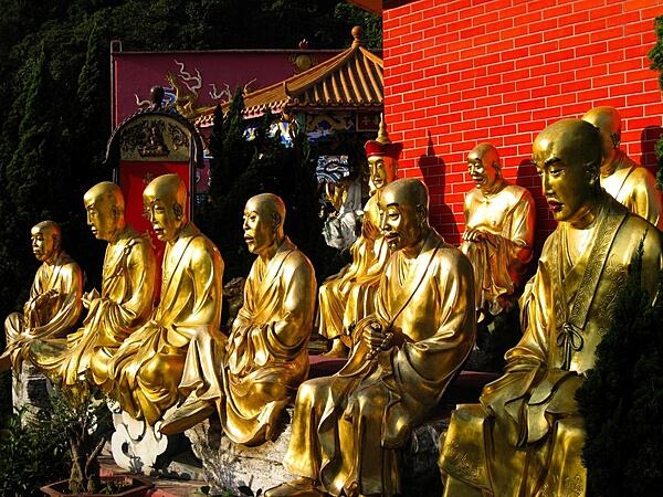 These golden Buddhas are located in the Temple of 10,000 Buddhas in Hong Kong. Life-size statues line the steep flight of over 400 steps leading to the temple. The actual number of Buddhas is more than 13,000.