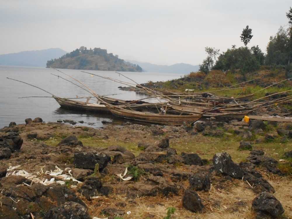 A view of fishing boats on Lake Burera, a twin lake with Lake Ruhondo, both of which are located in Rwanda’s northern region near Volcanoes National Park. The two lakes were created by volcanic activity from Mount Muhabura, whose lava blocked the flow of the Nyabarongo River. The island of Cyuza appears in the background.