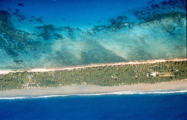 Aerial view of Chuuk Island shows the classic atoll configuration with the barrier reef on the outside exposed to the ocean (bottom) and the lagoon on the inside (top). Image courtesy of NOAA.