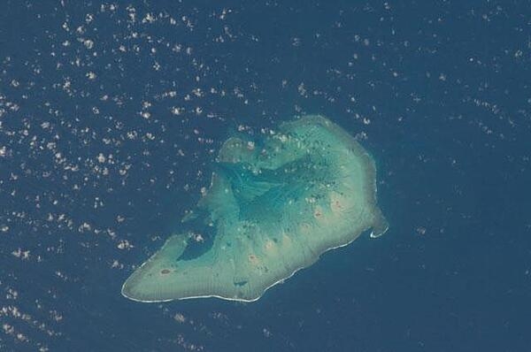 Ashmore Island (actually composed of three reef islets) is part of Ashmore Reef National Nature Reserve, which comprises several marine habitats, including seagrass meadows, intertidal sand flats, coral reef flats, and lagoons. 

This astronaut photo from 2011 shows that the reef making up the island is not continuous but has several breaks that allow for current and sediment inflow.

A memorandum of understanding between the Australian and Indonesian Governments allows Indonesian fishermen access to their traditional fishing grounds within the region, subject to limits. Image courtesy of NASA.