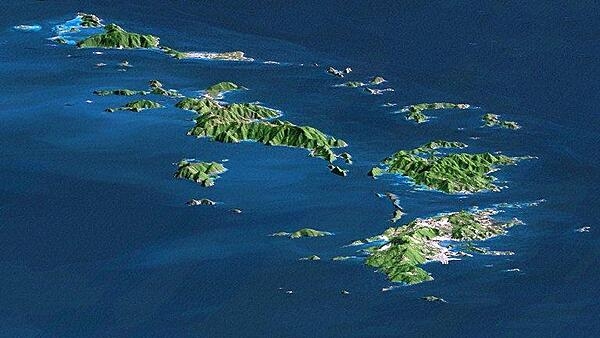 St. Thomas, St. John, Tortola, and Virgin Gorda are the four main islands (front to back) in this east-looking view of the US Virgin Islands and British Virgin Islands. For this view, a nearly cloud-free Landsat image was draped over radar elevation data, and shading was added to enhance the topographic expression. Elevation is shown with 1.5x scaled vertical exaggeration. Coral reefs fringe the islands in many locations and appear as very light shades of blue. Tropical vegetation appears green, while developed areas appear in shades of brown and white. Image credit: NASA, JPL, and NIMA.