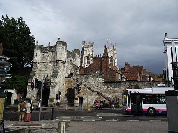 Much of York&apos;s ancient walls still survive; they are punctuated by four main gatehouses (referred to as &quot;bars&quot;). Bootham Bar has some of the oldest surviving stonework - dating to the 11th century A.D. It was built almost exactly on the site of the northwestern gate of Eboracum, the Roman settlement that evolved into York. This view, taken from Exhibition Square, shows York Minster, the city&apos;s famous cathedral, in the background.