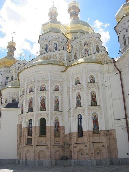 A view of the Uspensky Sobor (Dormition Cathedral) at the Kyiv Pechersk Lavra (Kyiv Monastery of the Caves) complex in Ukraine. The unpainted section shows what an earlier version of the church looked like before its 17th-century reconstruction in the Cossack Baroque style.