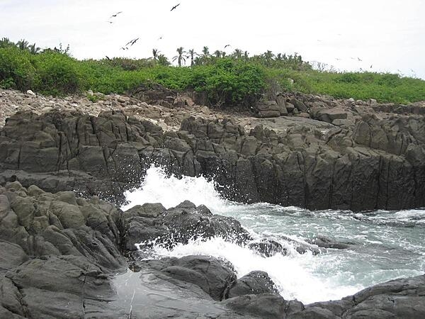 The rocky coast of Iguana Island on the Pacific coast of Panama.  Sparsely inhabited by humans, this wildlife refuge teems with amazing bird and marine life.