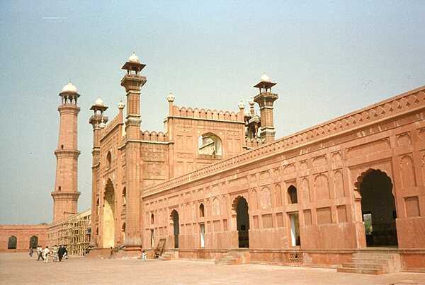 The entrance to Pakistan's Badshahi Mosque, or “imperial mosque,” as viewed from the mosque courtyard. Built by the Emperor Aurangzeb between 1671 and 1673, it remains the largest mosque of the Mughal period; its courtyard can accommodate 100,000 worshippers. The gateway leads out to the garden known as Hazuri Bagh, beyond which is the Alamgiri gate of the Lahore Fort.