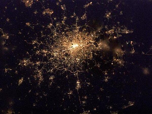 This intriguing &quot;globular cluster of stars&quot; is actually the &quot;constellation&quot; of city lights surrounding London as recorded February 2003 from the International Space Station. The encircling &quot;London Orbital&quot; highway by-pass, the M25, is easiest to pick out south of the city. Even farther south are the lights of Gatwick airport and just inside the western (left hand) stretch of the Orbital is Heathrow. Image courtesy of NASA.
