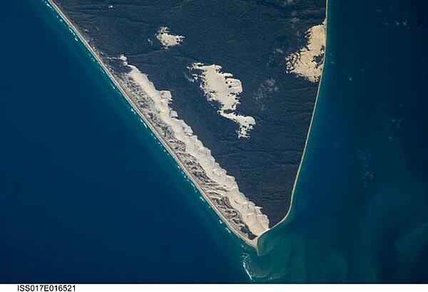 Sandy Cape and part of Fraser Island may be seen in this image photographed from the International Space Station. Fraser Island, the world&apos;s largest sand island, includes Great Sandy National Park and is located along the coastline of Queensland. The island was designated a World Heritage site in 1992, in part due to its outstanding preservation of geological processes related to sand dune formation. Image courtesy of NASA.
