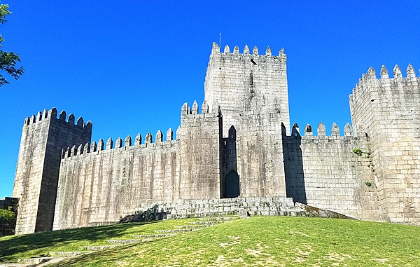 The castle in Guimaraes was built in the 10th century to protect a nearby monastery from Moors and Norsemen.  As the first capital of the nation and birthplace of its first king, Guimaraes it is one of Portugal's most historic cities  and one of the most attractive places to visit in the country. Its historic town center is listed as a World Heritage Site in recognition of its being an "exceptionally well-preserved and authentic example of the evolution of a medieval settlement into a modern town" in Europe.