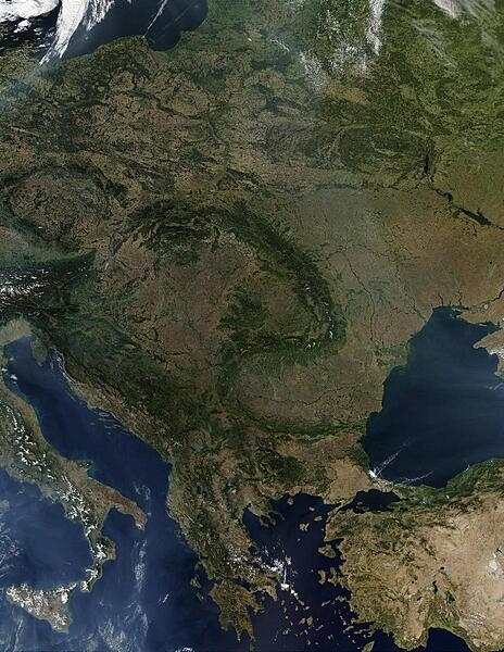 A virtually cloud-free view of Central Europe vividly displays the fishhook-shaped Carpathian Mountains that snake through the middle of the continent. Encompassed in this satellite view are all of Poland, the Czech Republic, Slovakia, Hungary, Romania, Slovenia, Greece, and all of the Balkan countries. Large parts of Lithuania, Belarus, Ukraine, Turkey, and Italy are also visible. Scattered fires are visible as red dots. Image courtesy of NASA.