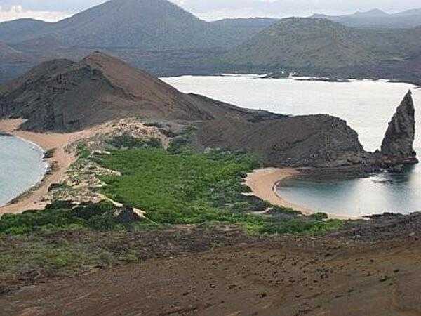 A beach view on the volcanic Galapagos Islands. In all there are 15 main islands, 3 smaller islands, and over 100 rocks and islets composing the archipelago, which is an Ecuadorian province, a national park, and a biological marine reserve.