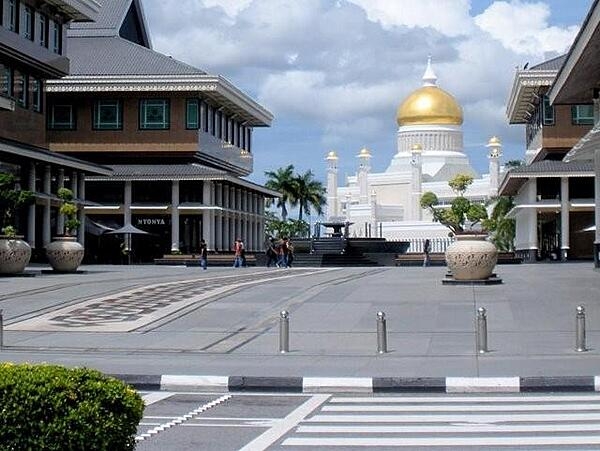 The Sultan Omar Ali Saifuddin Mosque in the water village of Kampong Ayer is a major landmark and tourist attraction in Brunei. Built in 1958, the structure is a mixture of Mughal and Italian architectural styles. Built on an artificial lagoon, the mosque is surrounded by lush gardens, fountains, and trees. Its most recognizable feature is the main dome covered in pure gold. The marble minaret, 52 m (171 ft) tall, affords a panoramic view of the capital city.  The mosque, named after the late 28th Sultan of Brunei, can accommodate 3,000 worshipers.