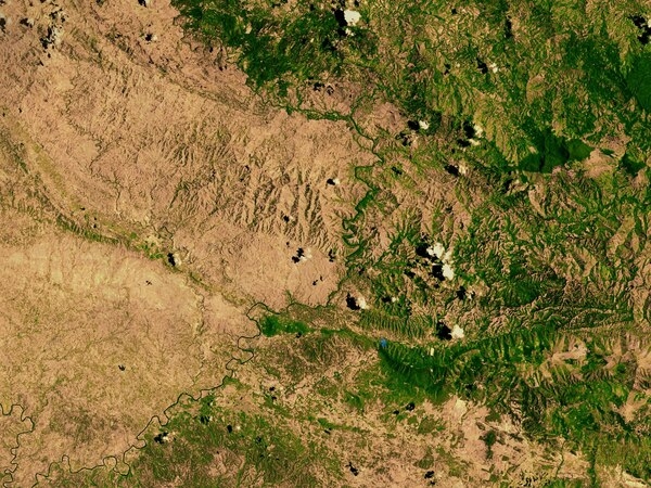 A satellite image of the border between the degraded landscape of Haiti (left) and the Dominican Republic (right) highlights the deforestation on the Haitian side. Photo courtesy of NASA.