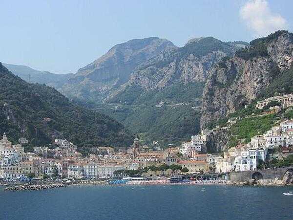 View of Amalfi, Italy, with Mount Cerreto (1,315 m; 4,314 ft) in the background. Amalfi was a maritime power with 70,000 residents until 1343, when an earthquake and subsequent tsunami destroyed most of the city. The tower of the Amalfi Cathedral (Duomo di Amalfi), built in 1208, can be seen in the foreground.