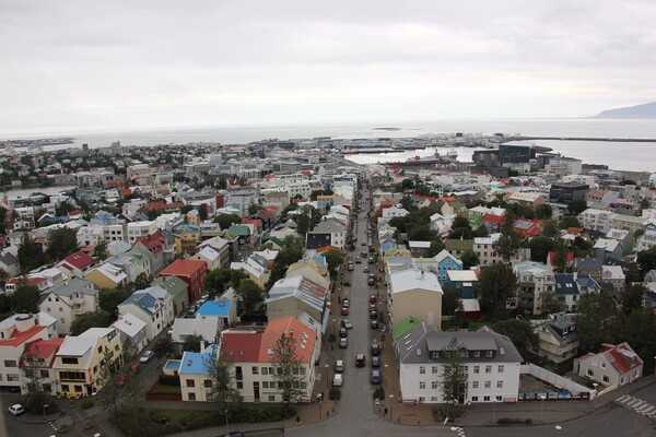 Reykjavík is the capital and largest city of Iceland, located on the southern shore of Faxaflói Bay. Steam from hot springs in the region is said to have inspired Reykjavík's name, which loosely translates to Smokey Bay.  Its latitude of 64°09' N makes it the world's northernmost capital city.