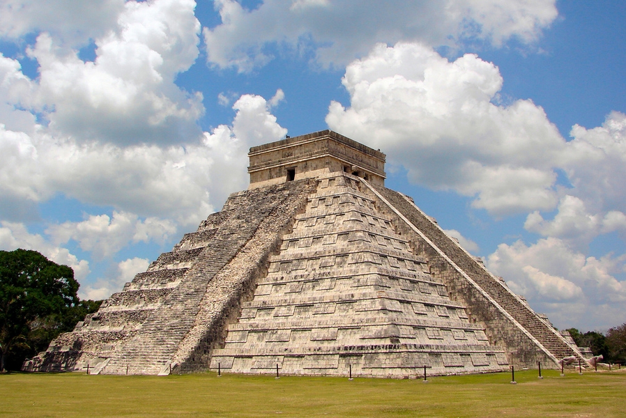 The east-side view of El Castillo (The Castle), the famous pyramid at Chichen Itza in the Yucatan peninsula, shows both restored and unrestored portions of the structure. The Maya center of Chichen Itza, which became a World Heritage Site in 1988, was founded in the fifth century A.D. A second settler infusion by migrating Toltecs from central Mexico occurred in the 10th century. A blending of Maya and Toltec architectural traditions developed in the following centuries until the site was abandoned about the middle of the 15th century.