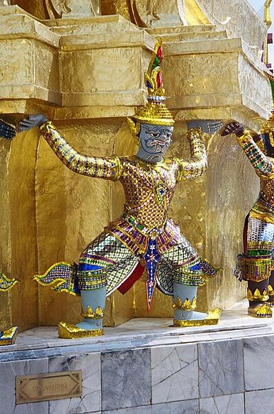 A mythological giant supports a golden chedi at the Wat Phra Kaew (Temple of the Emerald Buddha) in Bangkok.