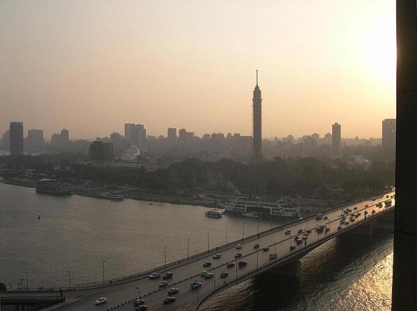 A view of Cairo from the Nile with the Cairo Tower, a free standing TV tower on Gezira Island, in the foreground.