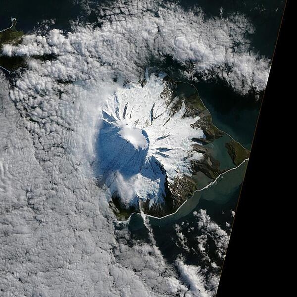 In October 2012, satellites measured subtle signals that suggested volcanic activity on remote Heard Island. These images, captured several months later, show proof of an eruption on Mawson Peak. By early April 2013, Mawson&apos;s steep-walled summit crater had filled, and a trickle of lava had spilled down the volcano&apos;s southwestern flank. Image courtesy of NASA.