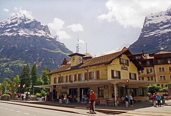 The train station in Grindelwald on a sunny day. Located in the canton of Bern, this agricultural community lies 1,034 m (3,392 ft) above sea level, and attracts tourists for hiking in the summer and skiing in the winter.