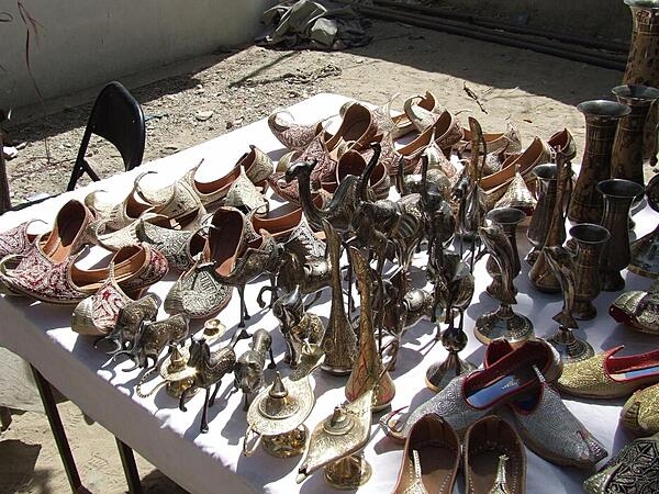 Shoes, sculptures, and goblets for sale at a Kabul bazaar.