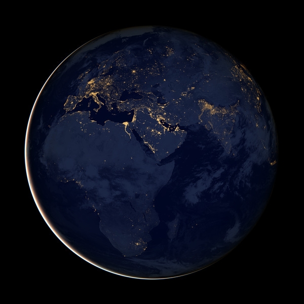 A global view of the Eastern Hemisphere at night assembled from satellite data. Europe and the Middle East are fairly well defined by city lights or gas flares, but much of the southern half of the image - including most of Africa and South Asia - is relatively dark. Image courtesy of NASA.