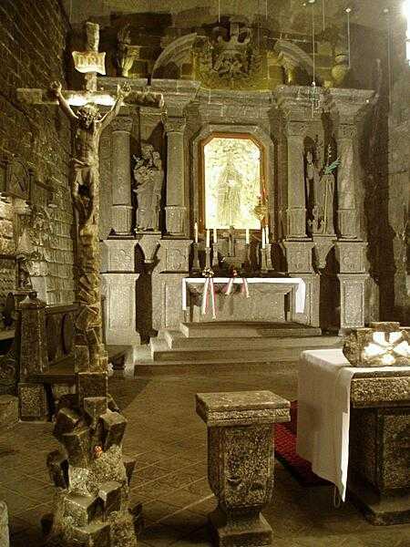 An altar constructed of salt in the Wieliczka Salt Mine in Poland. The mine was continuously in use from the 13th century until 2007. Today it is a popular tourist site.