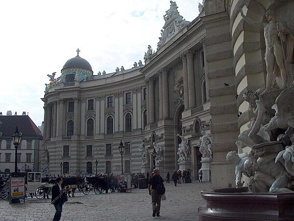 The Michaelertrakt (Michael&apos;s Wing) of the Hofburg (Imperial Palace) was designed by the renowned Austrian architect Joseph Emanuel Fischer von Erlach in 1726, but not actually constructed until 1889-1893! The fountain, Power on Land, may be seen on the right.