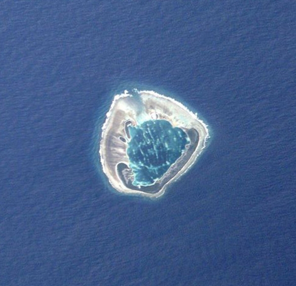 Ducie Island, the easternmost of the Pitcairn Islands, as seen from space. The uninhabited atoll includes a central lagoon. Despite its sparse vegetation, the atoll is an important breeding ground for a number of bird species. Photo courtesy of NASA.