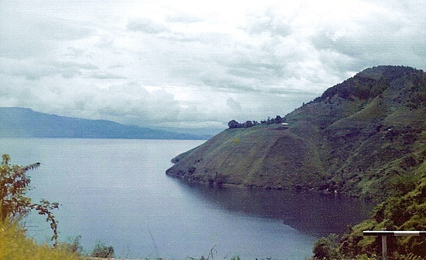 Lake Toba is located in the middle of the northern part of the island of Sumatra, occupying the caldera of a supervolcano. The lake is about 100 km (62 mi) long, 30 km (19 mi) wide, and up to 505 m (1,657 ft) deep. It is the largest lake in Indonesia and the largest volcanic lake in the world. 
Lake Toba is the site of a supervolcanic eruption estimated at a Volcanic Explosivity Index (VEI) of 8, the largest recorded value on the index. Recent advances in dating methods suggest the date was 74,000 years ago and that it represented a climate-changing event. It is the largest-known explosive eruption on earth in the last 25 million years.  Lake Toba was designated a UNESCO Global Geopark in July 2020.