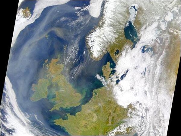 Dust from North Africa mingled with other aerosols in the skies over the United Kingdom (left of center) and Ireland (farther west) on 18 April 2003. In this scene, the dust is more prominent to the north over the Atlantic, where it can be seen as a tan swirl west of Norway. West of Ireland, the haze is grayer, and is more likely pollution. In the United Kingdom, a few bright plumes of white could be associated with fires. Photo courtesy of NASA.