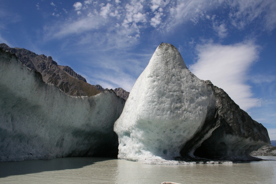 On the eastern edge of Aoraki/Mount Cook in New Zealand, a moraine (accumulated glacial debris) created a glacial lake where the Tasman Glacier ended.