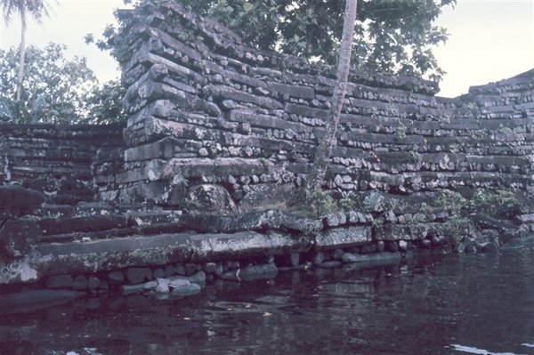 Part of the seawall enclosing Nan Madol on Temwen Island in the present day Madolenihmw district of Pohnpei state, in the Federated States of Micronesia. The ruins were built on 92 artificial islets, stretching out 1.3 km (0.8 mi) in length and 0.6 km (0.4 mi) in width. Photo courtesy of NOAA.