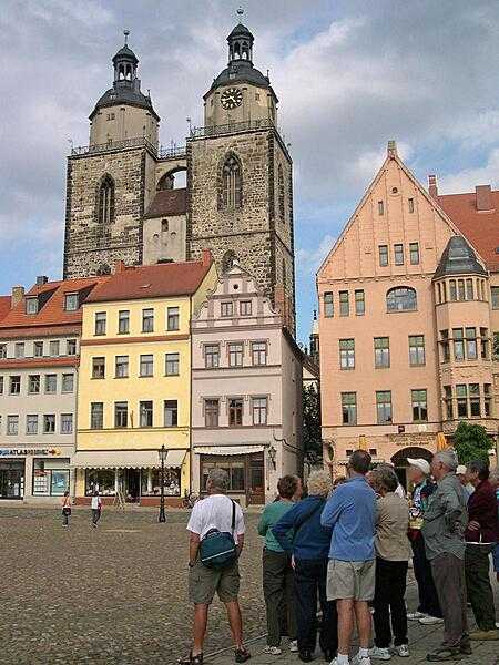 The Market Place of Wittenberg, Germany, with the Stadt Kirche (City Church) -- also known as Marienskirche (St. Mary's Church) or Mother Church of the Reformation -- in the background. Martin Luther did most of his preaching in the church, some parts of which date to the 13th century.