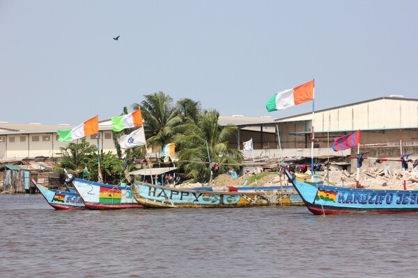 Cote D’Ivoire’s distinctive national tri-color flag flies freely on the prows of various boats anchored in Abidjan harbor.