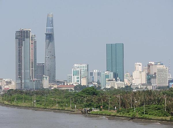 View of Ho Chi Minh City (aka Saigon) from the Saigon River. Saigon is Vietnam&apos;s major port and, with 8 million inhabitants, its largest city. It was called Saigon until 1975 when it was renamed Ho Chi Minh City following its capture by North Vietnamese communist forces. Although the city&apos;s commercial core is officially called Saigon, the entire city is widely referred to as Saigon even in the North. The city was architecturally influenced by the French during their colonial occupation of Vietnam. Numerous classical Western-style building in the city reflect this, so much so that Saigon was referred to as &quot;The Pearl of the Far East&quot; or &quot;Paris in the Orient.&quot; In more recent years, a building boom has transformed the skyline of the city.